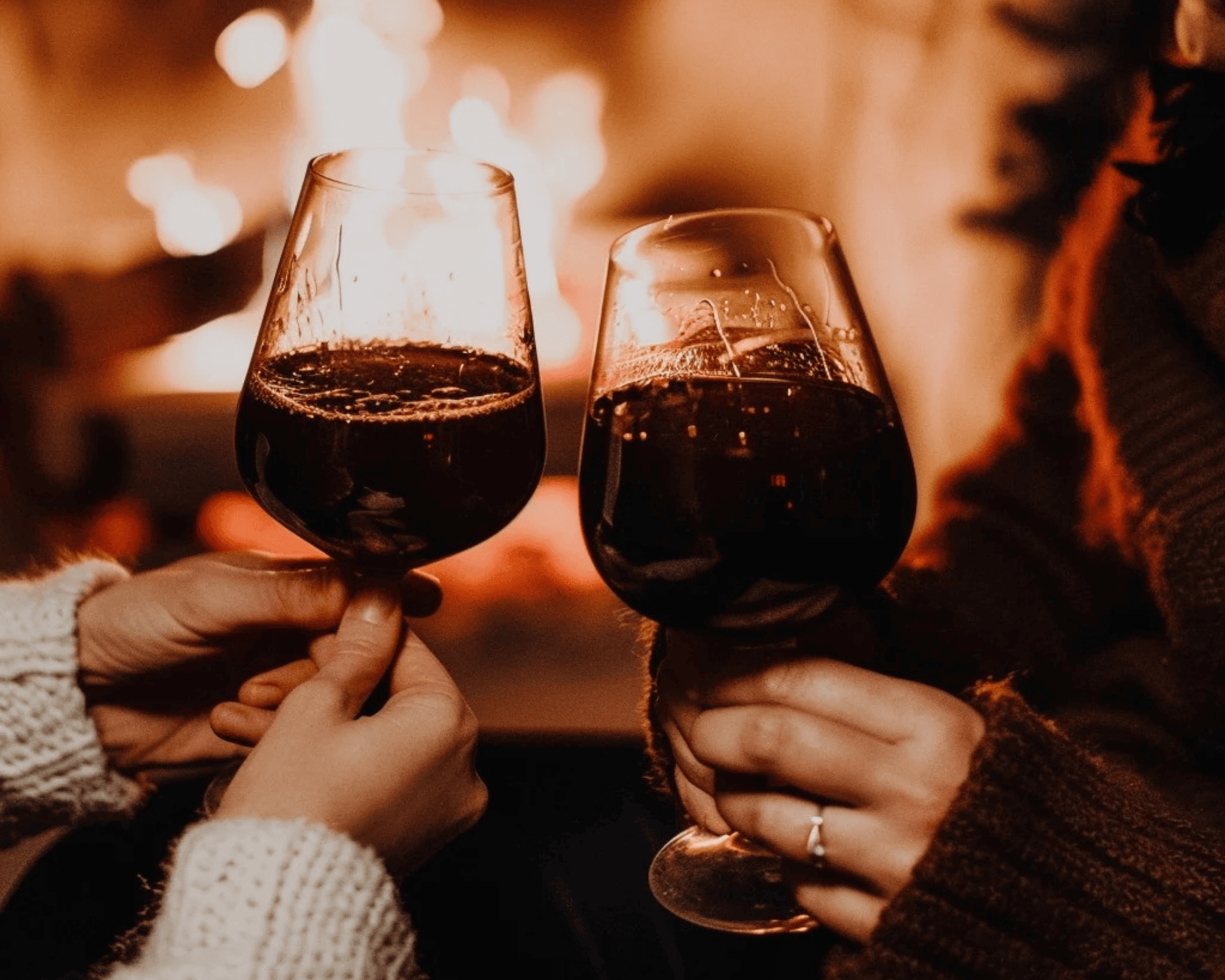 Cozy winter evening with red wine by the fireplace, enjoying rich warm wines during the colder season