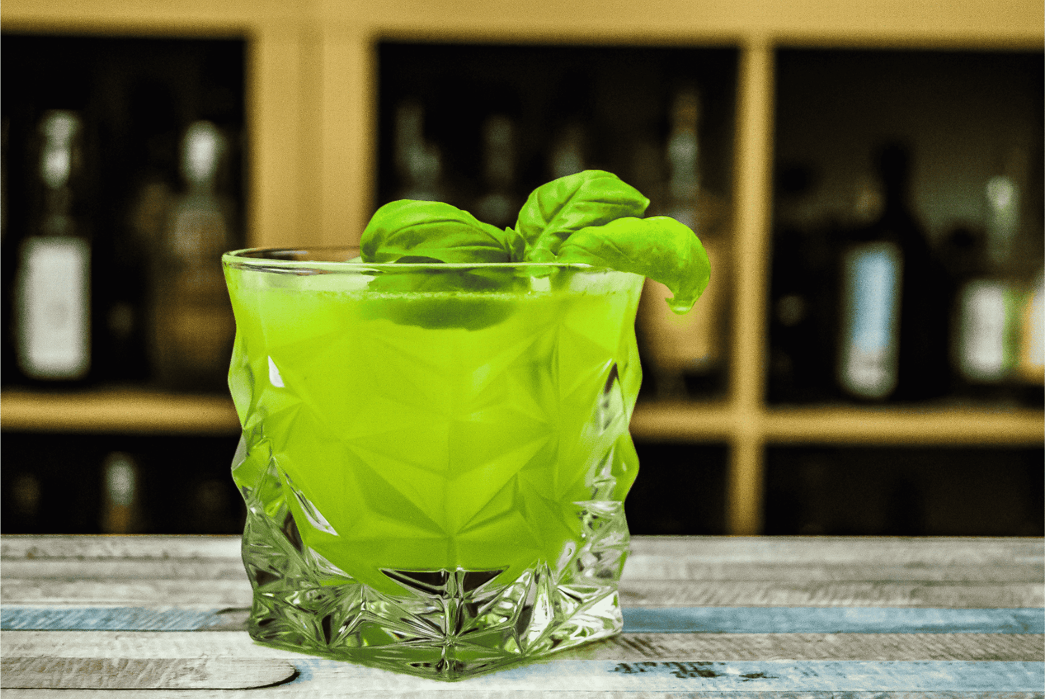 Vivid green cocktail in a textured glass, a bold Irish cocktail crafted with Irish whiskey for a festive green drink