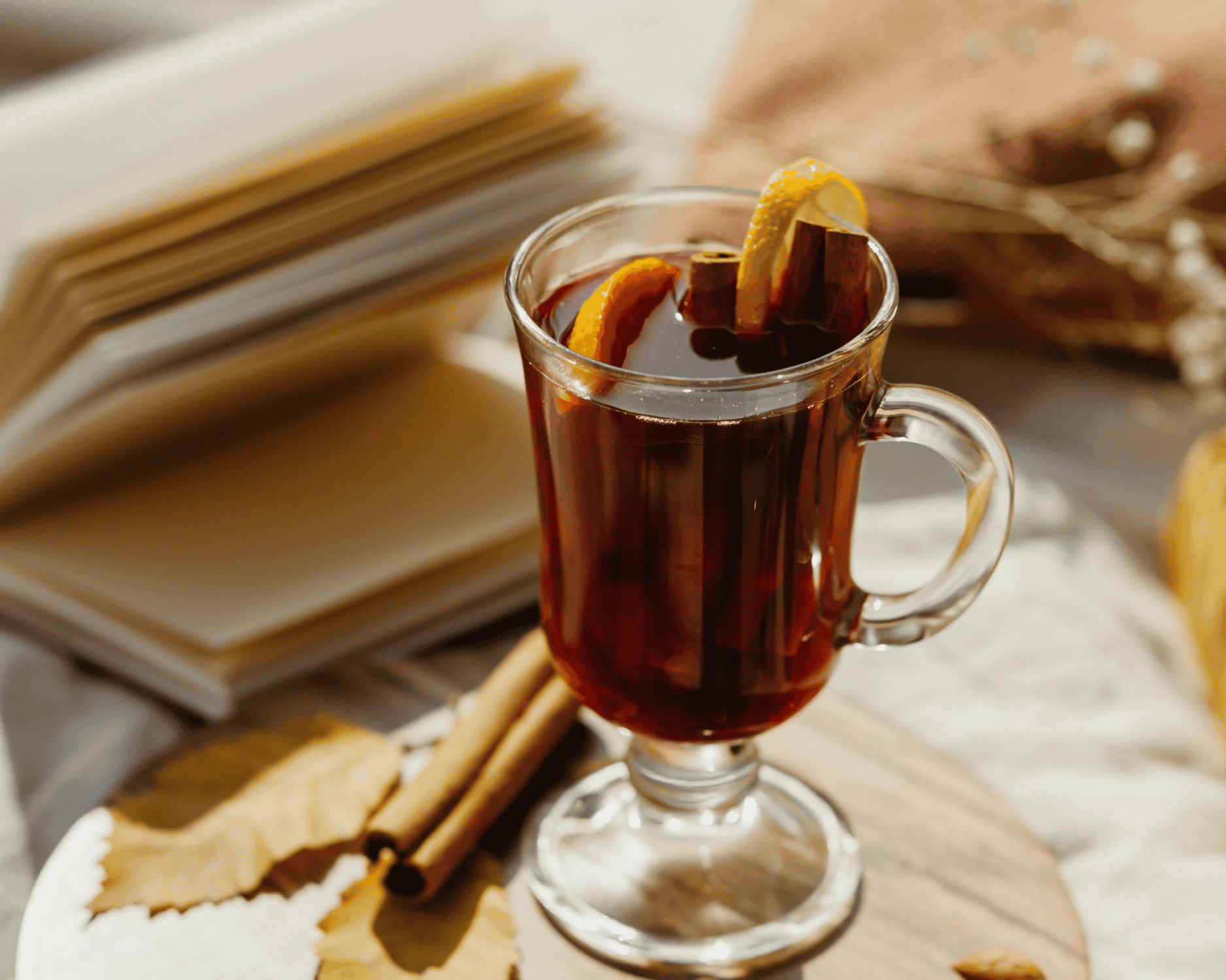 Steaming glass of mulled wine with orange slices and cinnamon, a classic warm winter wine for cold-weather sipping
