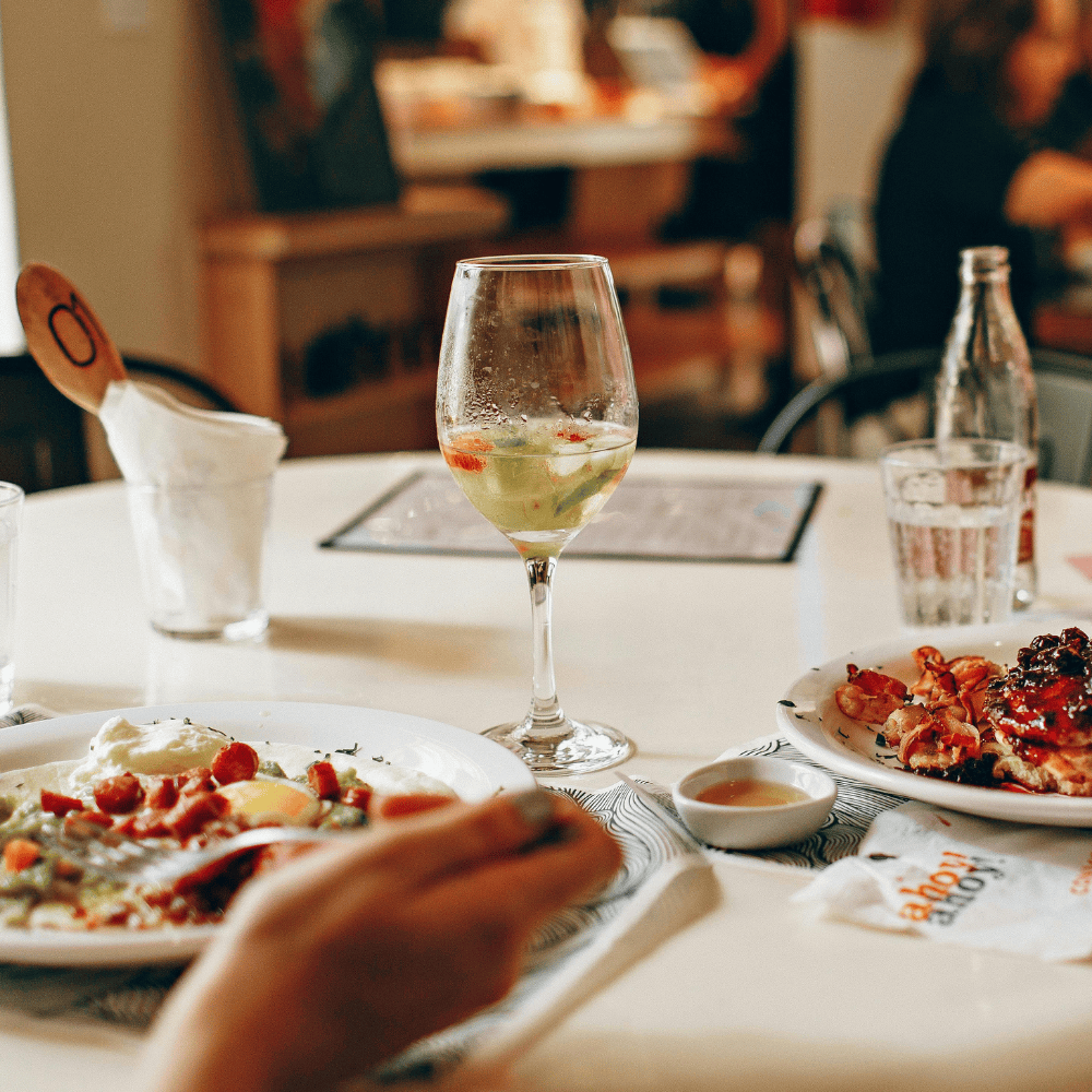 A refreshing glass of white wine served with a hearty brunch spreadperfect pairing for a relaxed Mother's Day wine celebration