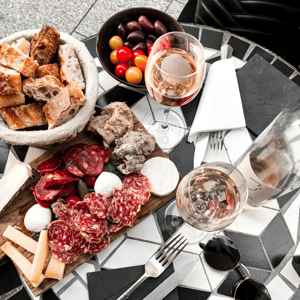 Ros wine and a savory charcuterie board create a cozy setup for spring gatherings and stylish wine for brunch moments